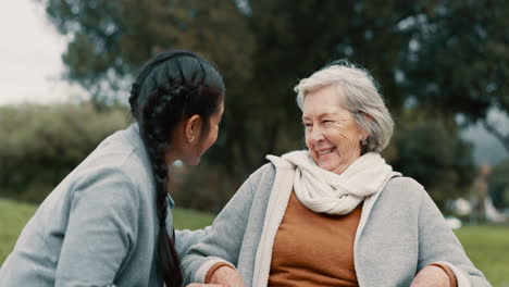 Caregiver-helping-woman-with-disability-in-park