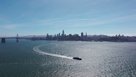 large boat in the san francisco bay with san francisco and oakland bridge