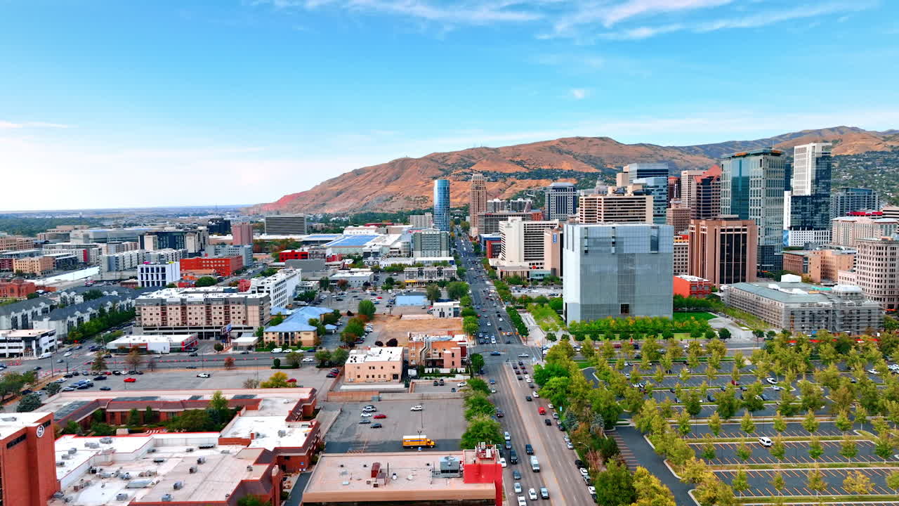 Salt Lake City USA, 1 August 2025: Aerial view of Salt Lake City with mountains in the background. Downtown Salt Lake City with busy streets, modern skyscrapers, and mountain scenery