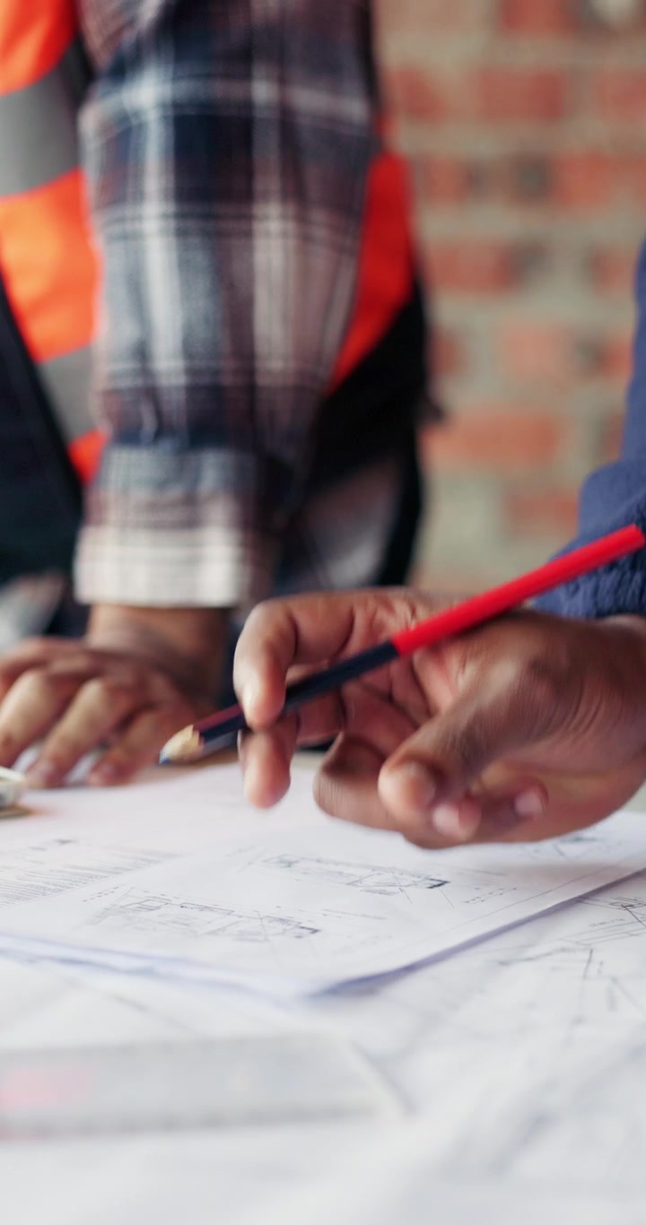 Architects Reviewing Construction Blueprints on a Table