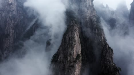 huangshan mountain peaks rising up above clouds, anhui china, aerial