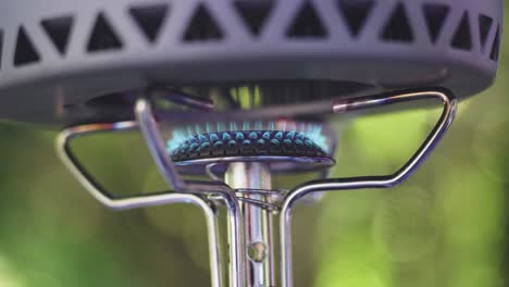 close up of gas burner with lush green background