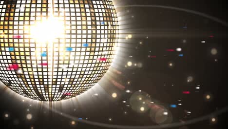 animación de una bola de discoteca iluminada que gira con el destello de la lente sobre un fondo negro