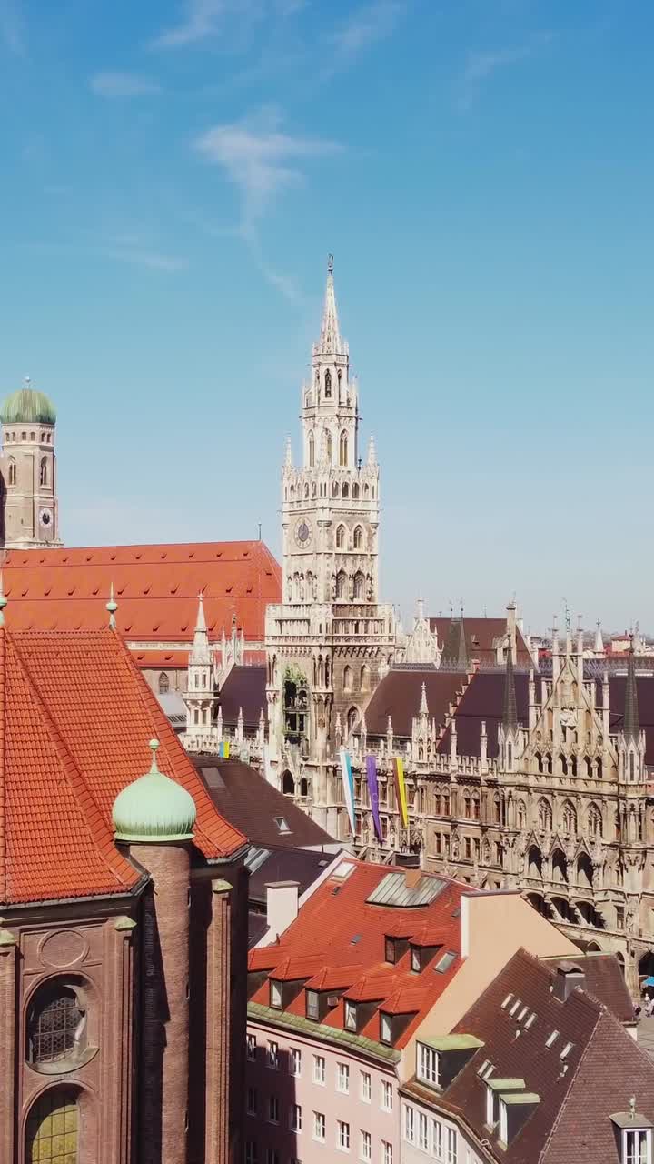 A vertical pan shot showcasing Munich’s famous architecture from above the city’s rooftops.