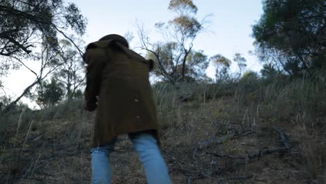 A-bushman-climbs-up-a-hill-in-the-Australian-outback