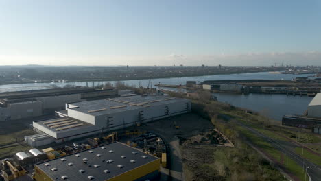 high angle pan over vast industrial area with large river
