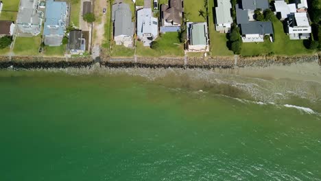 calm waters splashing against rockwall of beach front properties