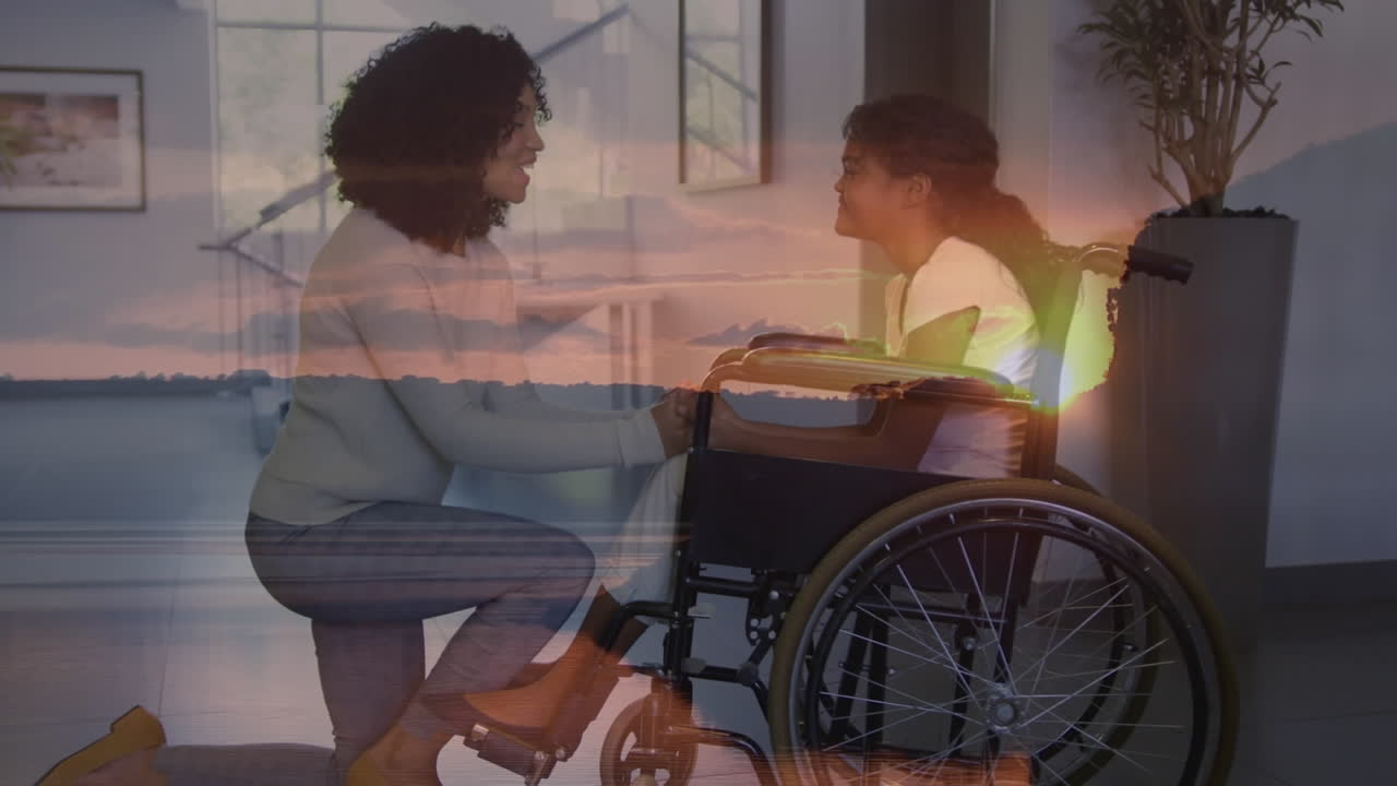 Animation of landscape over biracial mother her disabled daughter in wheelchair