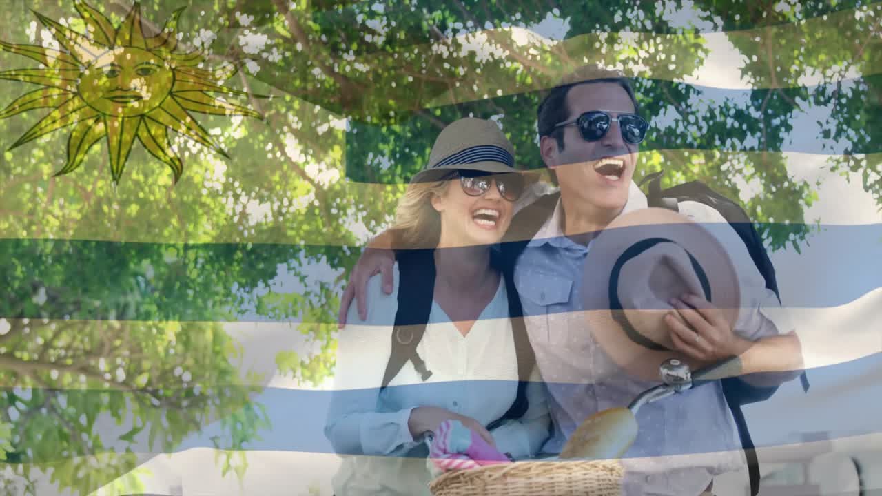 Happy couple with picnic basket and hats over Uruguay flag animation