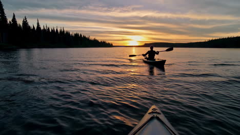 serene kayaking on a lake at sunset