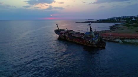 drone pushes over the edro lll shipwreck at sunset