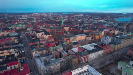 aerial view of downtown stockholm, sweden at sunset, central vintage buildings and streets, high rise drone shot