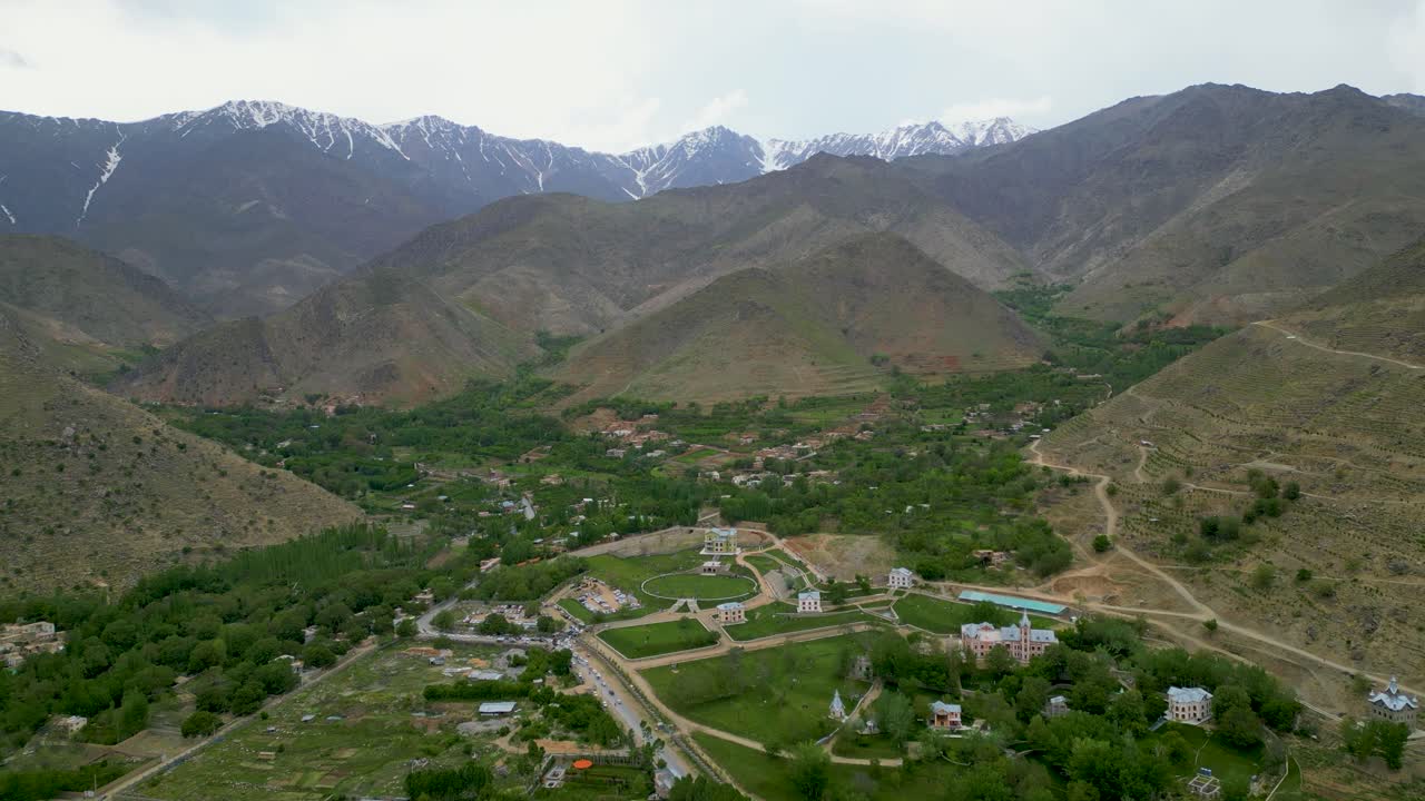 Aerial drone view of a mountain village in lush, rugged nature near Kabul, Afghanistan