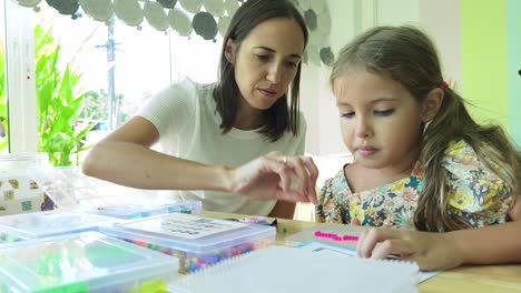 mother and daughter enjoying beading time