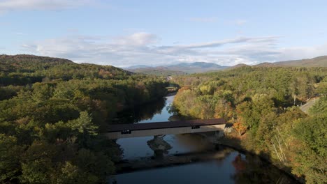 amazing view of bridge over river with scenic new england nature backdrop