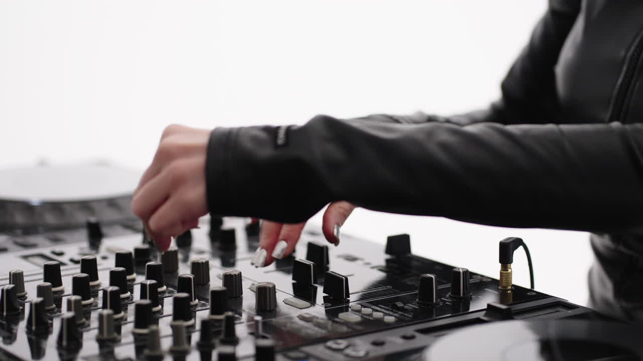 Woman DJ mixing music on a professional mixer
