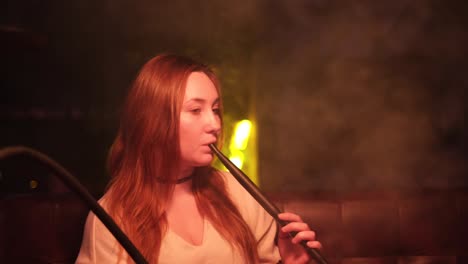 woman smoking hookah at night