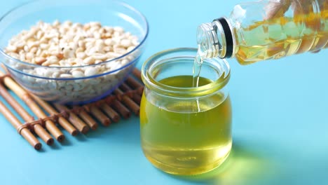 pouring peanut oil in glass jar