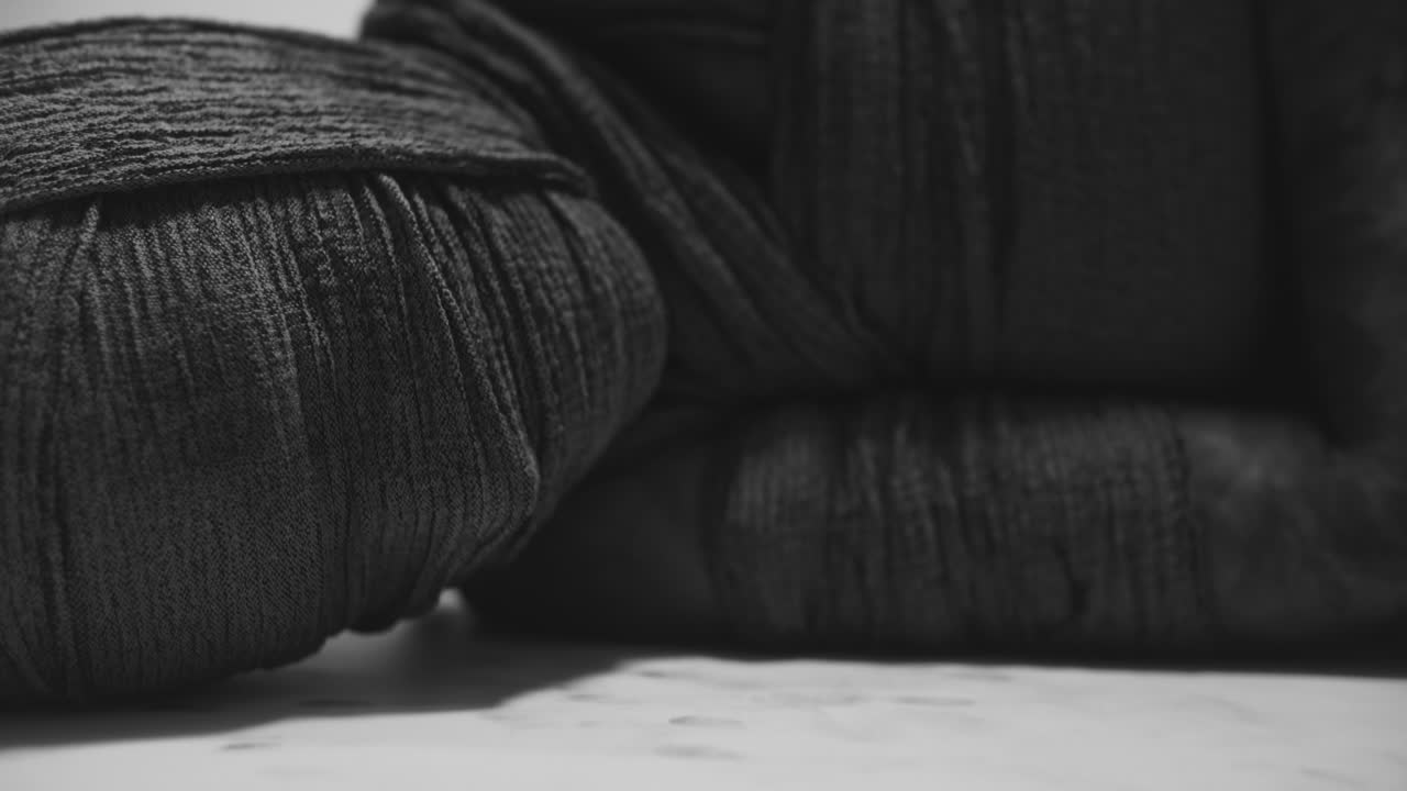 A mummy of a woman lying on the white backdrop