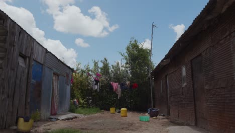 rustic dwelling with laundry drying under the sun in a rural area during a clear day