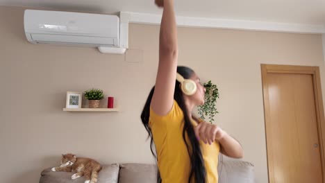 woman listening to music and dancing at home