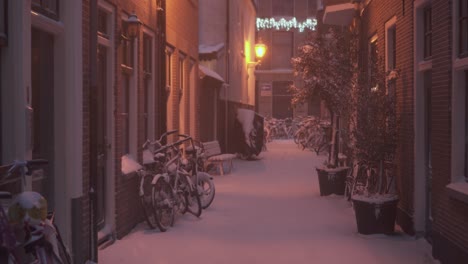 walking through snowy dutch city streets at night, winter alleyway view