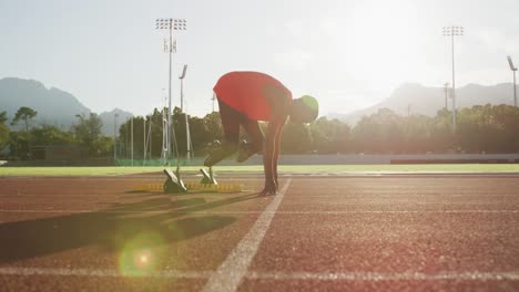 disabled mixed race man with prosthetic legs starting a race