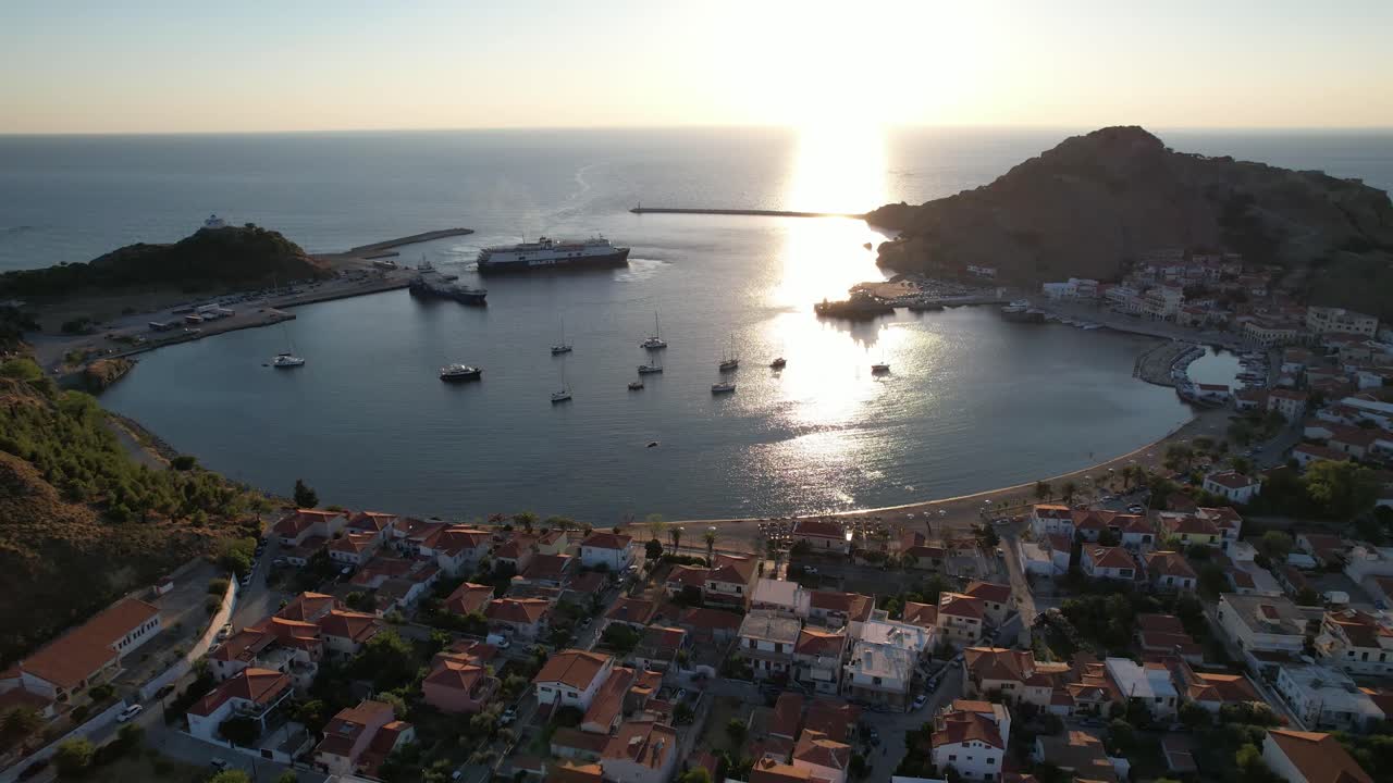 Myrina Port and City Center Aerial Panoramic View, Ferry Arrives in Limnos Greece, Backlit Shot, Afternoon Lighting