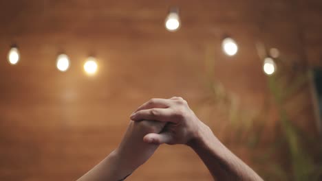 romantic view of two hands playing with love together. male and female hands isolated on blurred background. love relationship concept.