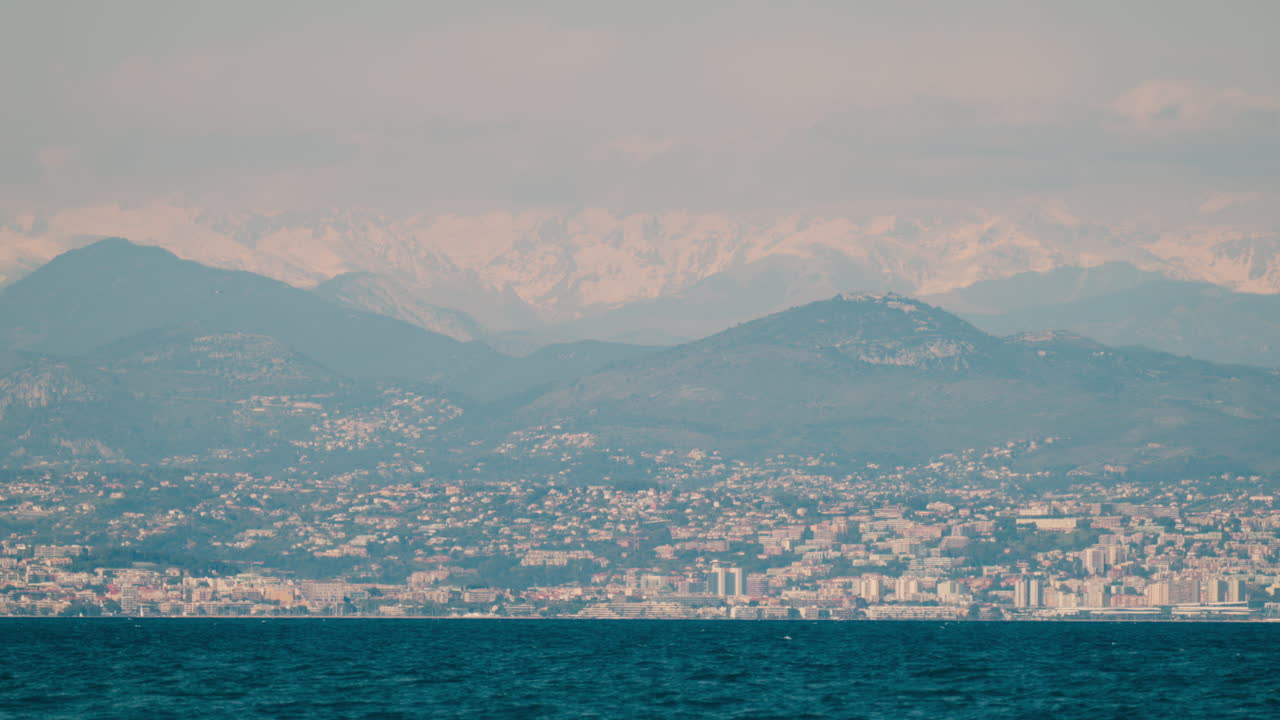 Distant view of the Cap d'Antibes peninsula with the mountains on the background