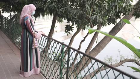 woman in abaya by a river