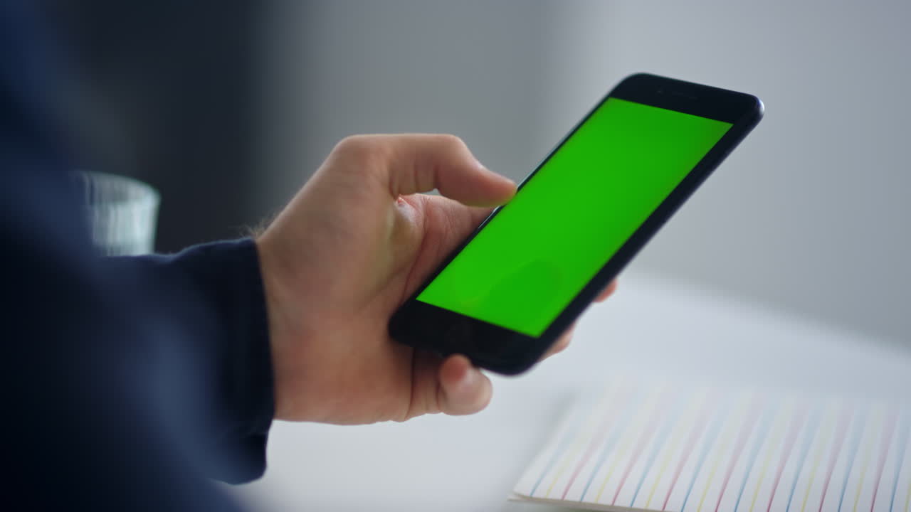 Male professional texting sms on green screen mobile in slow motion ...