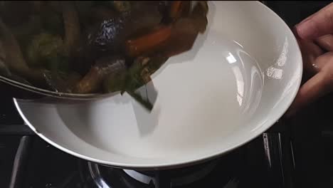 close-up-shot-of-delicious-asian-veggies-being-cook-in-high-heat-and-serve-in-plate