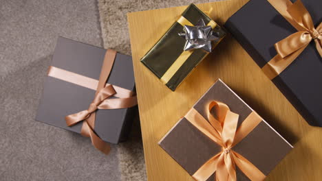 overhead shot of gifts or presents wrapped on table at home