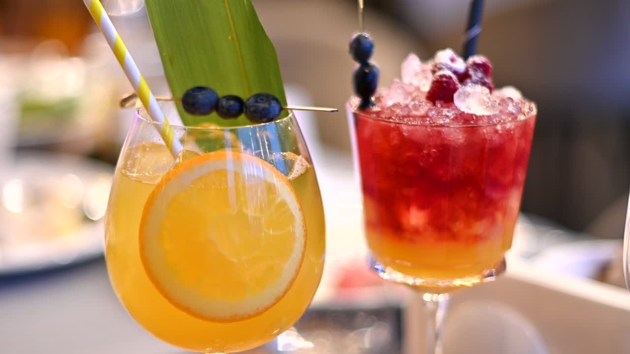 Two cocktails sitting on a table at a restaurant