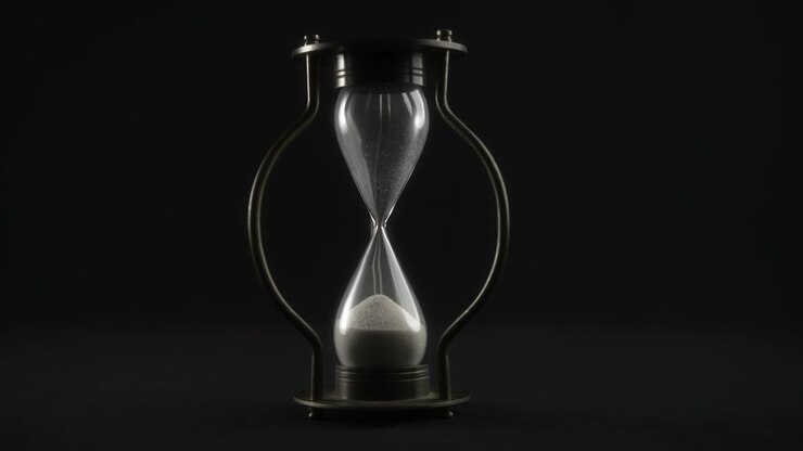 Hourglass Measuring Time Against a Dark Background