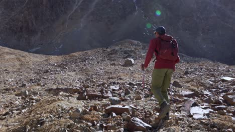 hiker walking over challenging terrain in the andes mountains at high elevation. slow motion, 4k