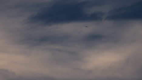 airplane flying in a cloudy sky