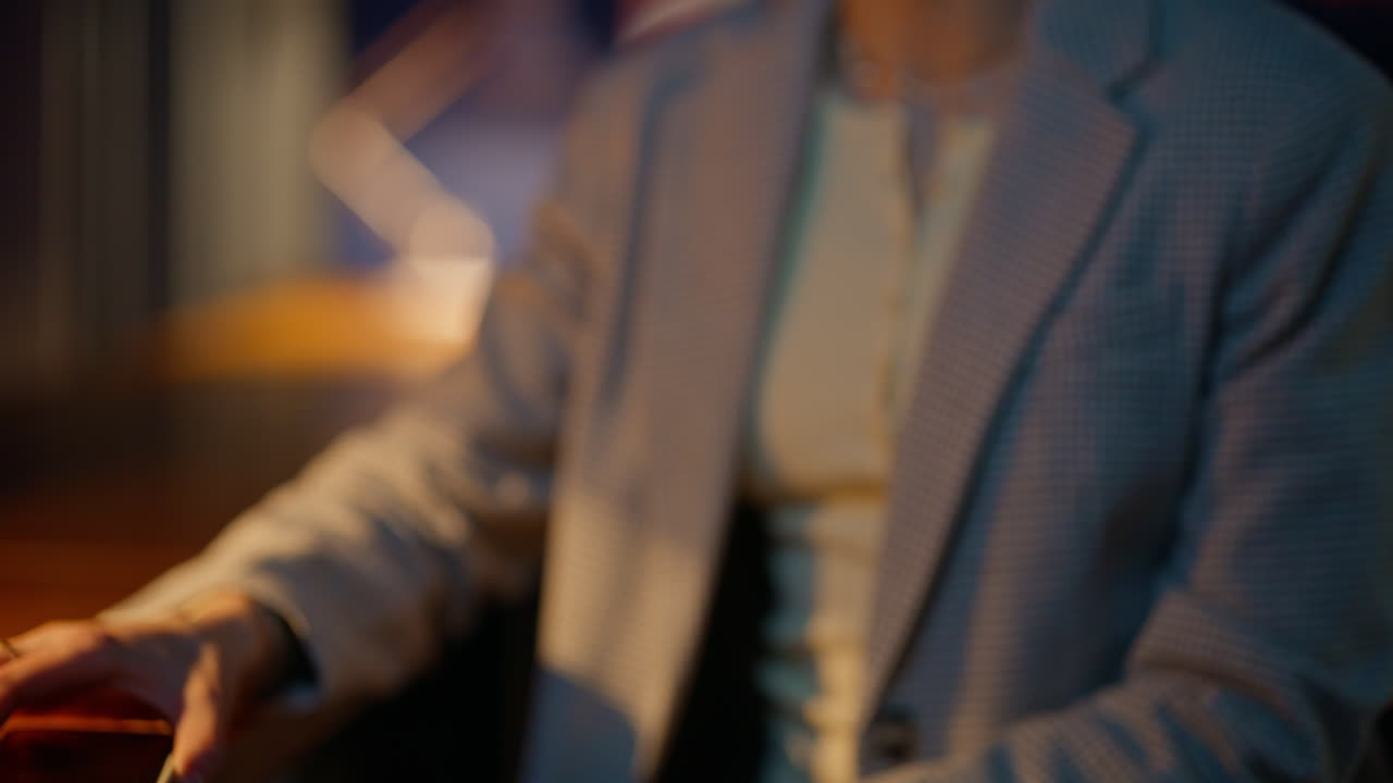 Unknown woman paying bill with cellphone in evening restaurant dinner portrait