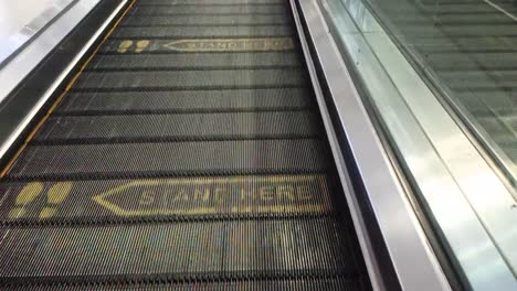 mark "stand here" at escalator at airport of soekarno-hatta, part of angkasa pura company