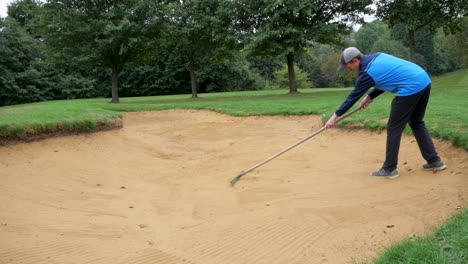 Slow-motion-of-player-raking-the-bunker