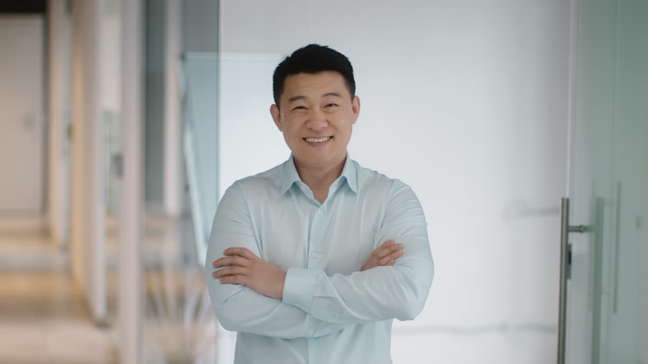 Smiling Businessman in Office Corridor