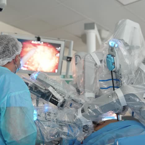 professional surgeon holding a tool and using it in operation. professional looks at the screen to see the run of the operation