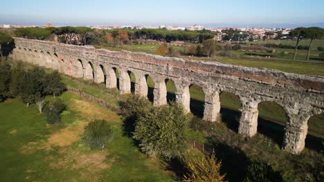 drone flies over claudio aqueduct on beautiful sunny day in rome, italy