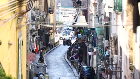 people and vehicles in a narrow street