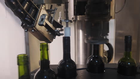 machinery corking wine on a conveyor belt at a wine factory