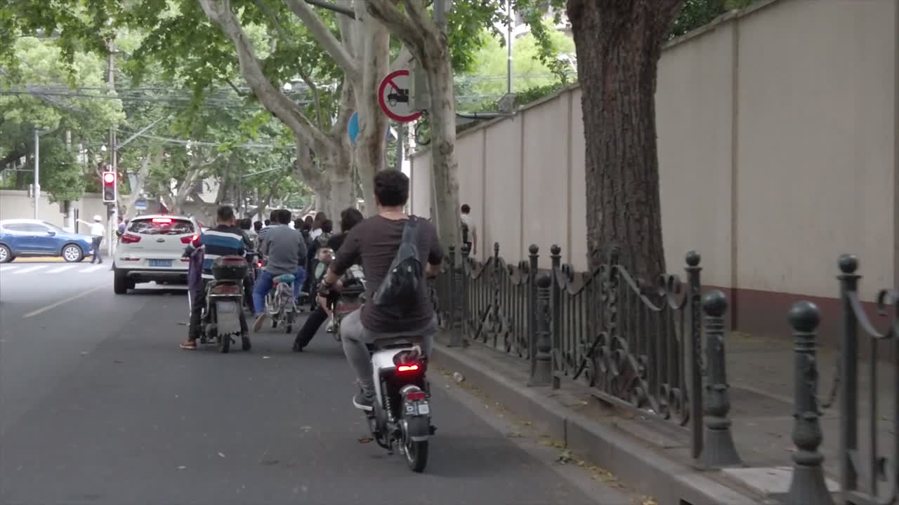 Electric scooter in traffic, Shanghai, China