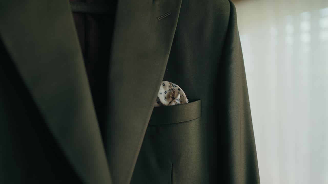 groom suit jacket with folded handkerchief detail indoors