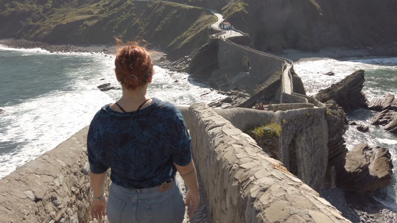 Woman walking on a stone bridge