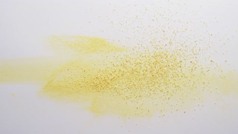 video of close up of yellow sand grains and copy space on white background